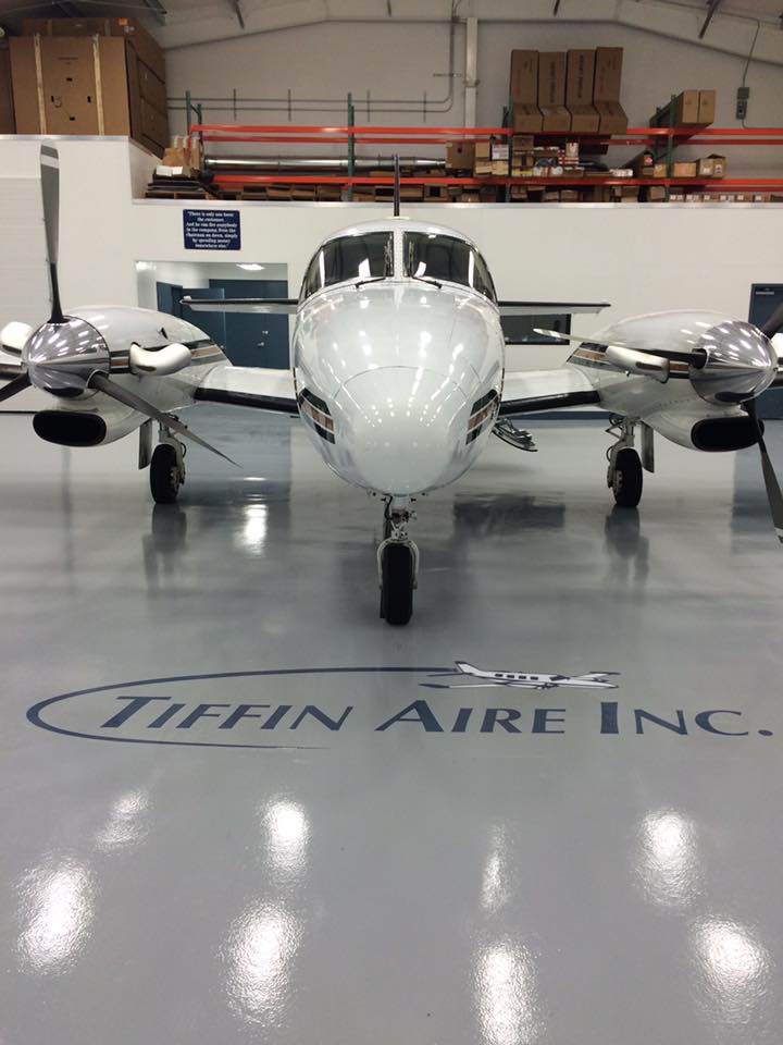 Light-gray 123 Resinous epoxy floor in an aircraft hangar with a twin-engine airplane