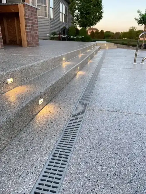 Graniflex flexible concrete coating on a pool deck with step lights