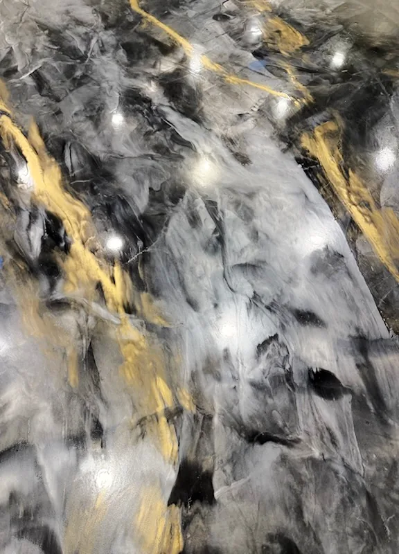 Metallic Marble epoxy floor with black and gold swirls