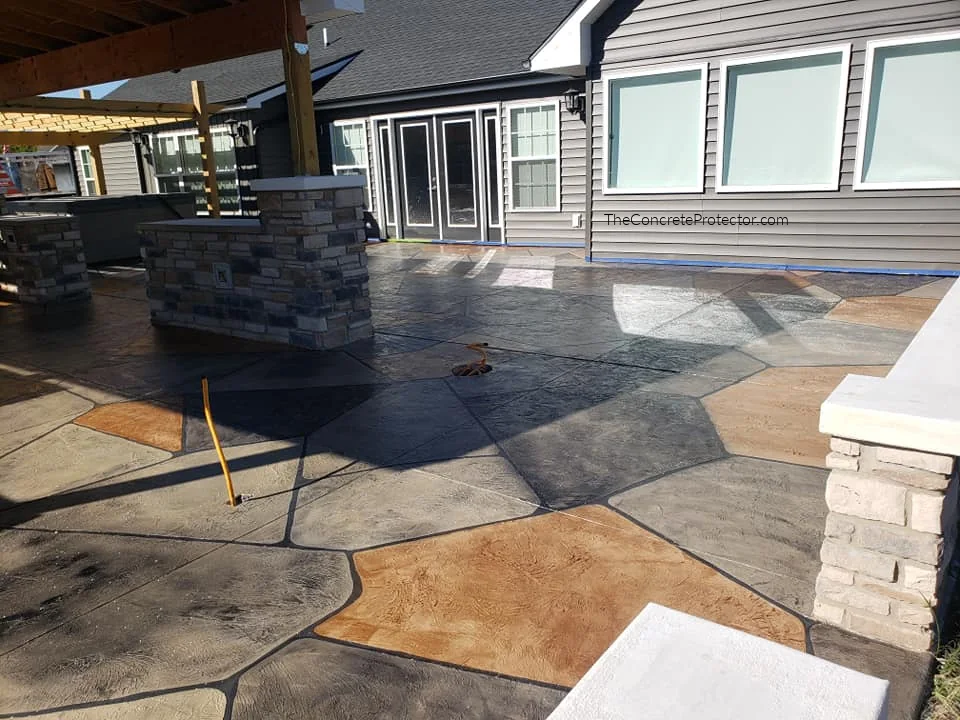 Grand Flagstone patio surrounding a built-in outdoor kitchen and grill island