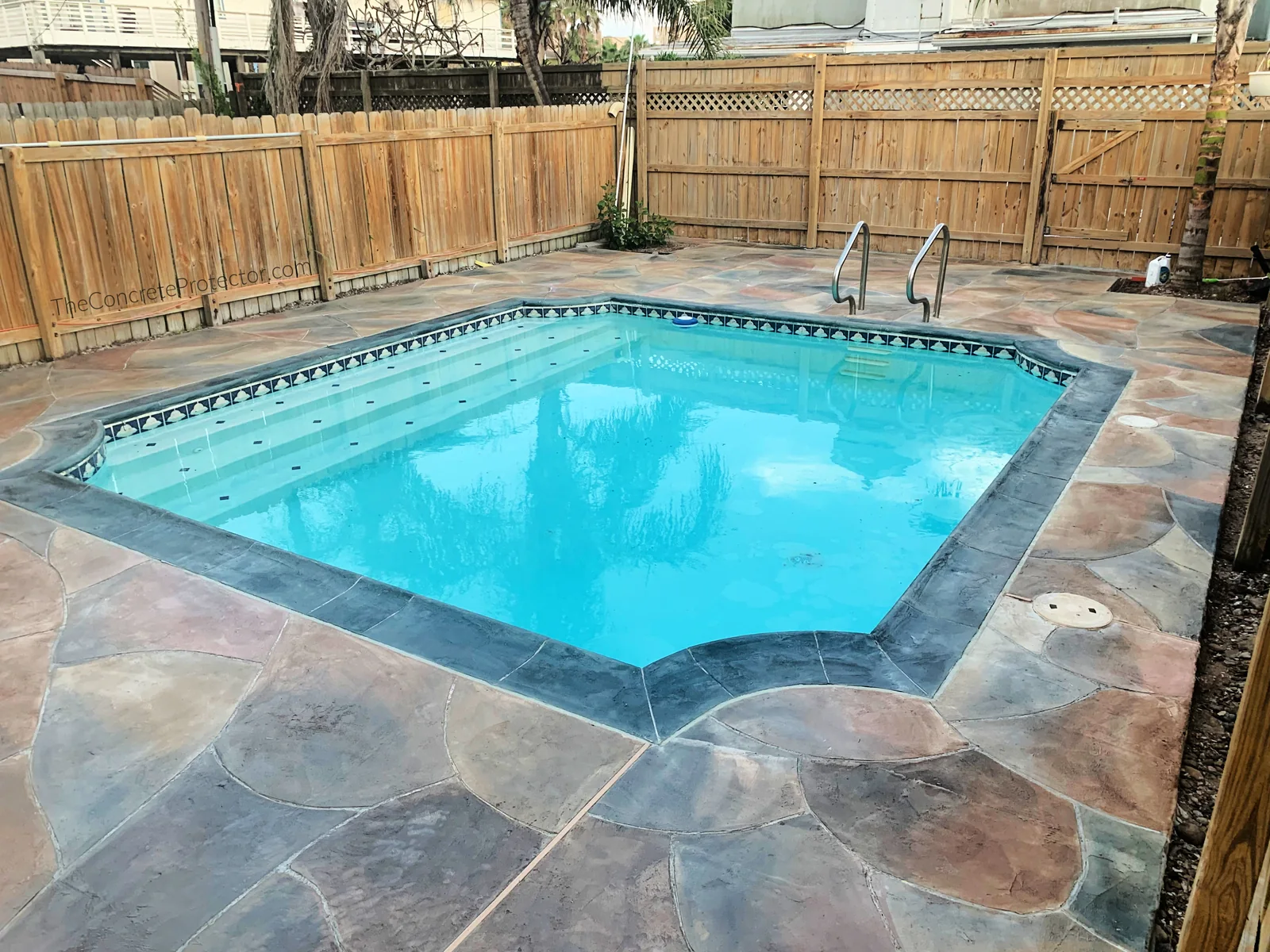 Grand Flagstone coating on an inground pool deck in a multi-tone gray blend