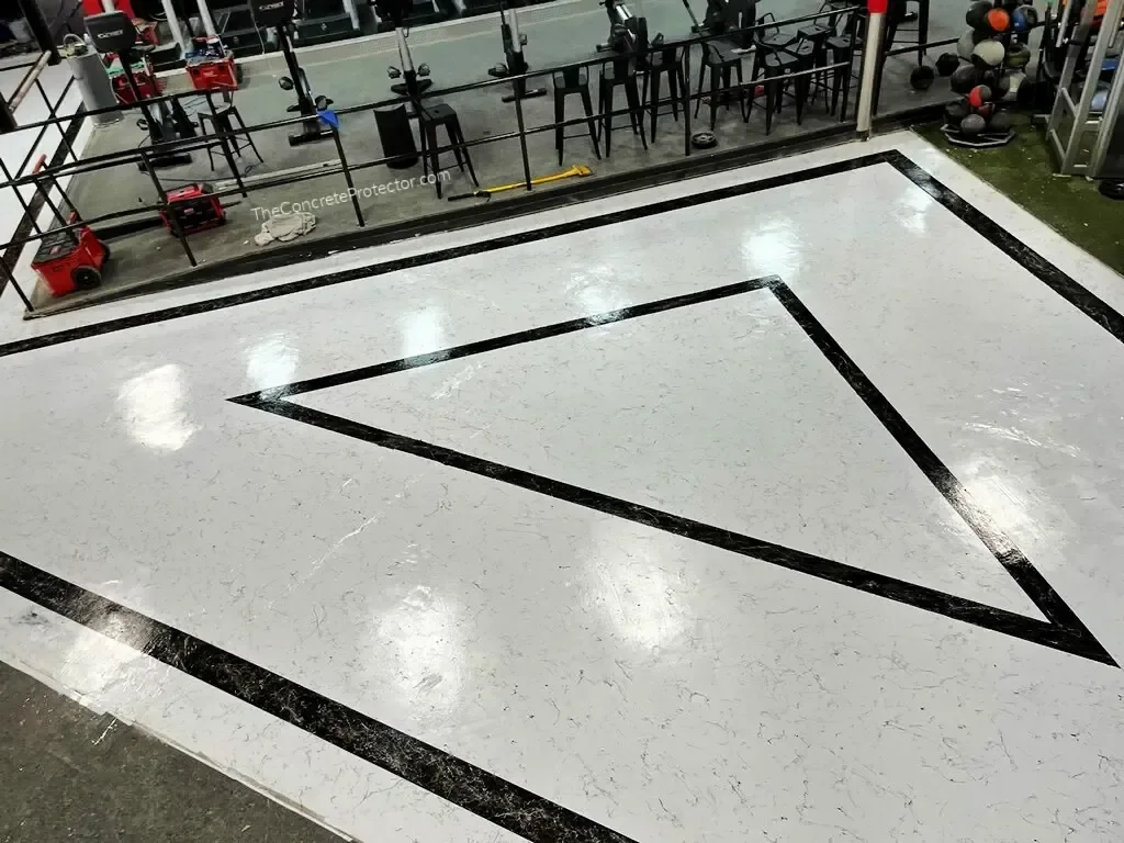 Italian Marble gym floor in bright white with a black marble chevron border inlay