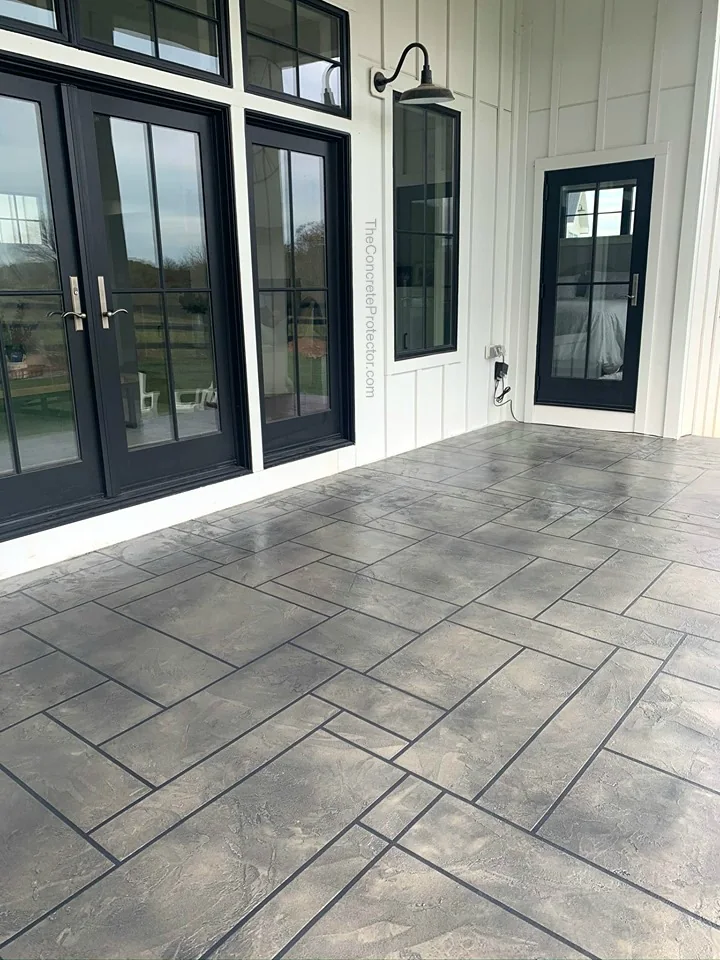 Tuscan Slate in an ashlar tile layout across a covered entryway with black patio doors