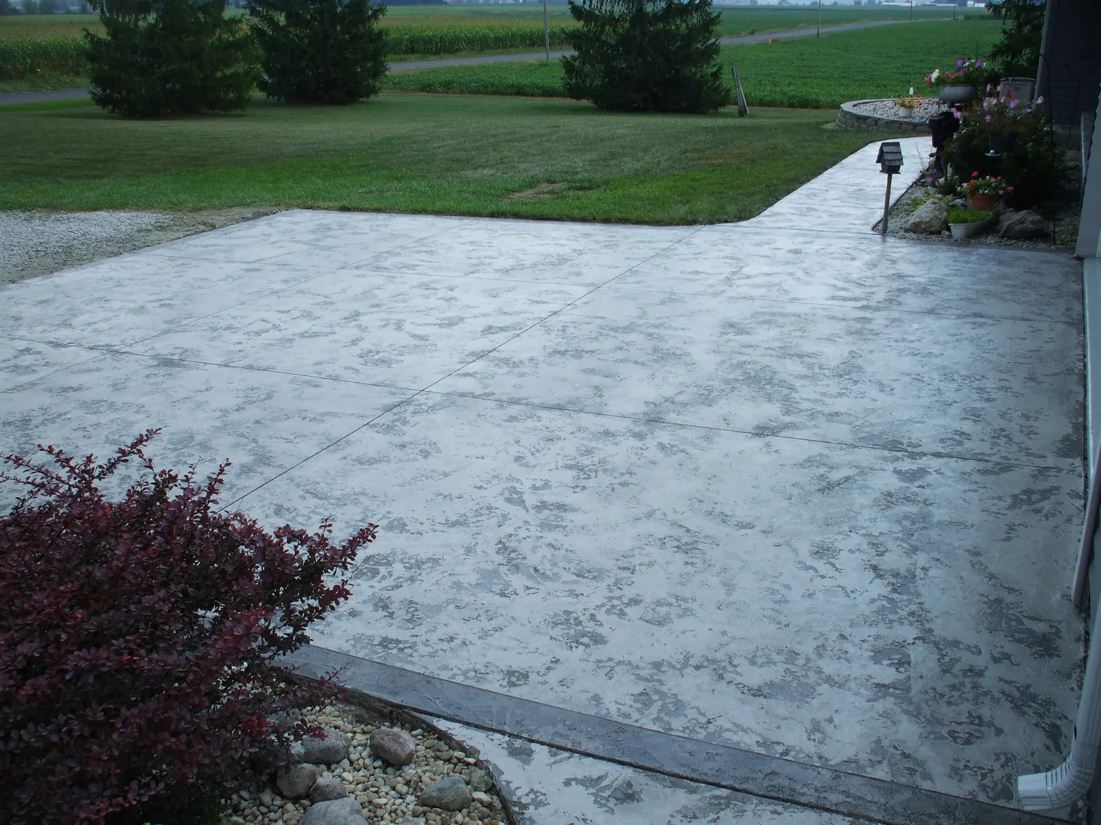 Tuscan Slate driveway resurfaced in grey, carried from the garage out to the street