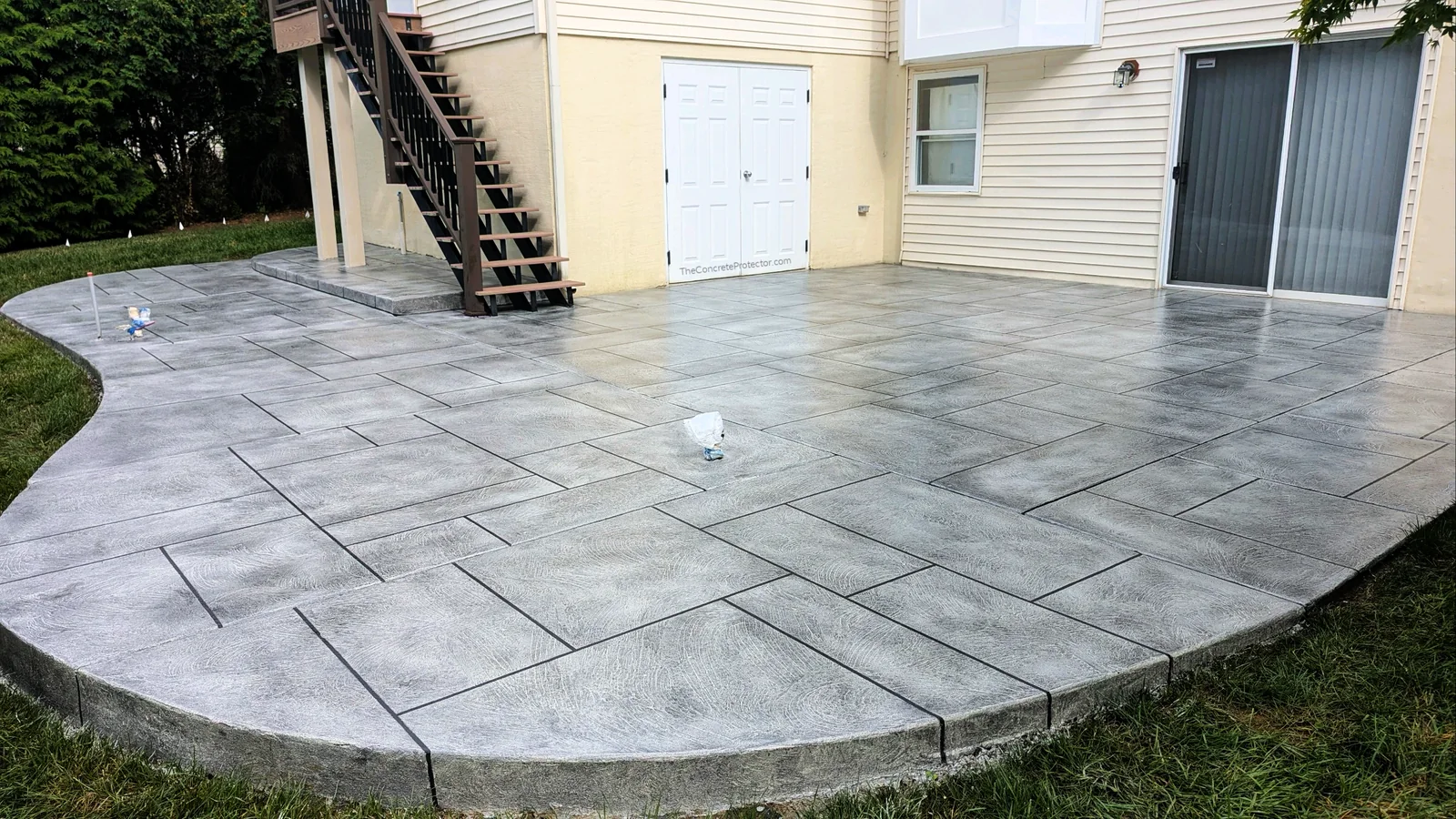 Tuscan Slate patio finished with a graphite stain in a wide ashlar tile layout